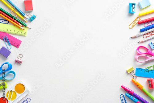 Frame of colorful school supplies on white background. Back to school concept. Flat lay, top view, overhead.