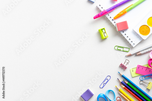 Frame of school stationery on white background. Flat lay, top view, space for text. Back to school concept. photo