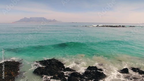Aerial: Waves Crashing on tropical beach. Cape Town, South Africa