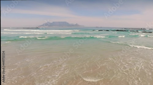 Aerial: Waves Crashing on tropical beach. Cape Town, South Africa