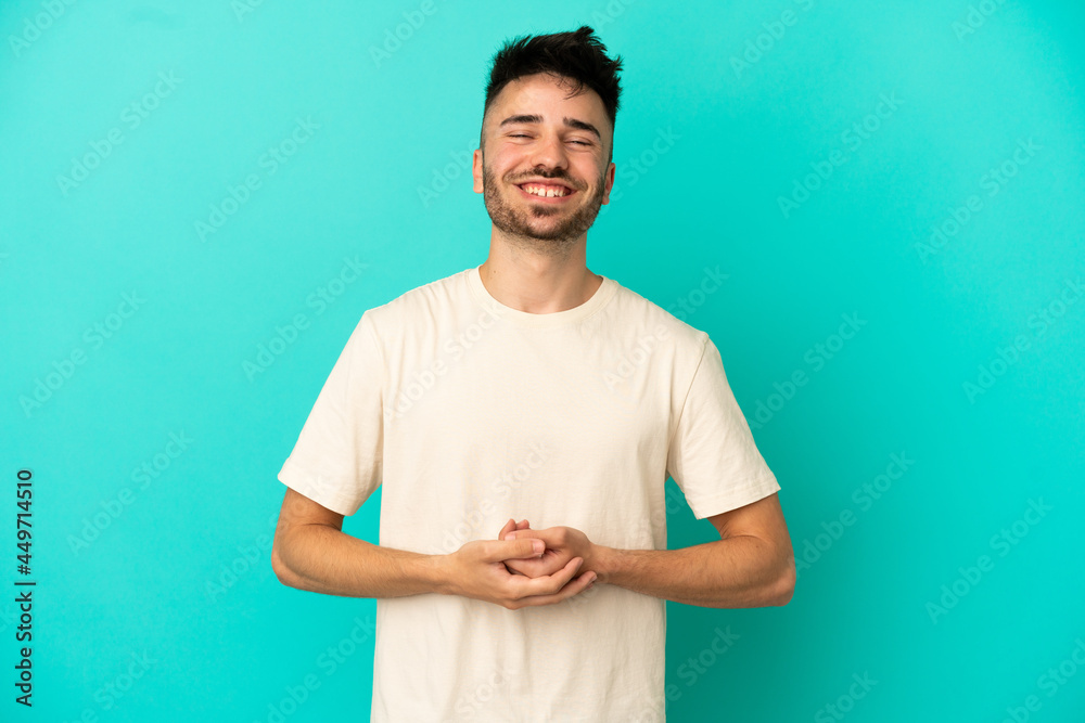 Young caucasian man isolated on blue background laughing Young caucasian man isolated on blue background laughing
