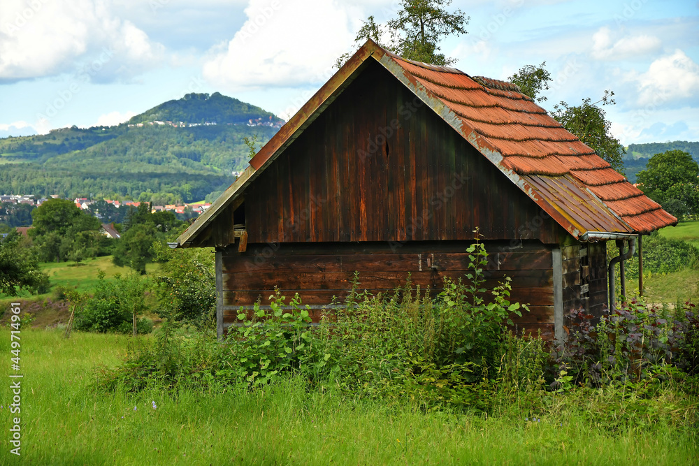 old barn with hill in the background