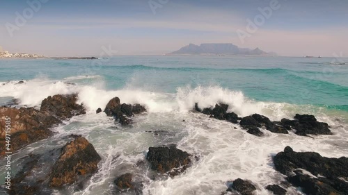 Aerial: Waves Crashing on tropical beach. Cape Town, South Africa