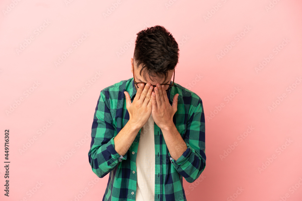 Young caucasian man isolated on pink background with tired and sick expression Young caucasian man isolated on pink background with tired and sick expression