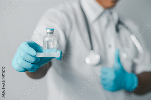 Doctor or scientist in sanitary uniform showing coronavirus vaccine, healthcare and medical concept. 