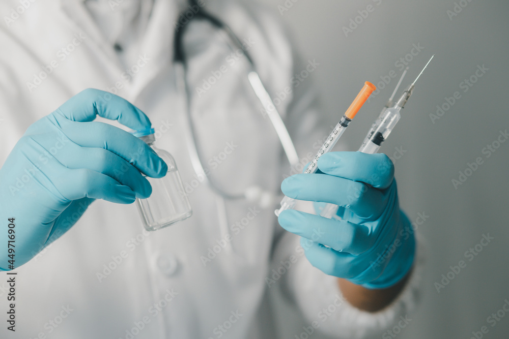 A doctor or scientist in a medical research laboratory holding a syringe containing a liquid vaccine analyzes an antibody sample to boost the patient's immunity.
A doctor or scientist in a medical research laboratory holding a syringe containing a liquid vaccine analyzes an antibody sample to boost the patient's immunity.