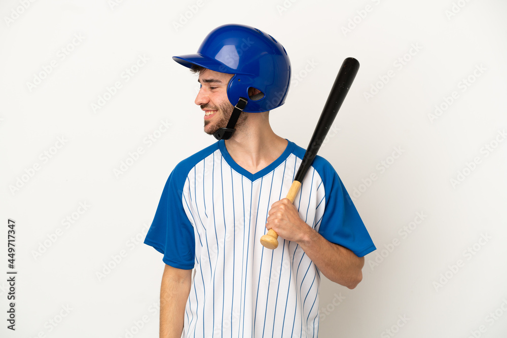 Young caucasian man playing baseball isolated on white background looking to the side and smiling Young caucasian man playing baseball isolated on white background looking to the side and smiling