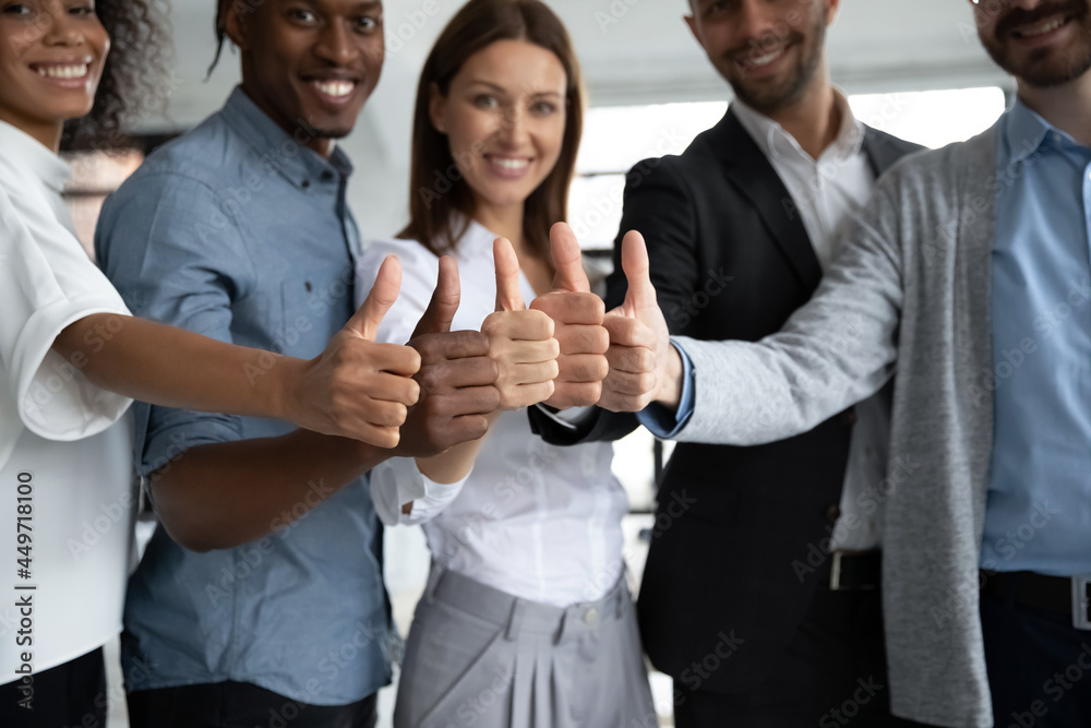 Crop close up portrait of smiling multiracial employees show thumb up give recommendation. Happy diverse multiethnic colleagues coworkers recommend good quality company service. Review concept. Crop close up portrait of smiling multiracial employees show thumb up give recommendation. Happy diverse multiethnic colleagues coworkers recommend good quality company service. Review concept.