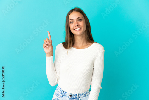 Young woman over isolated blue background showing and lifting a finger in sign of the best