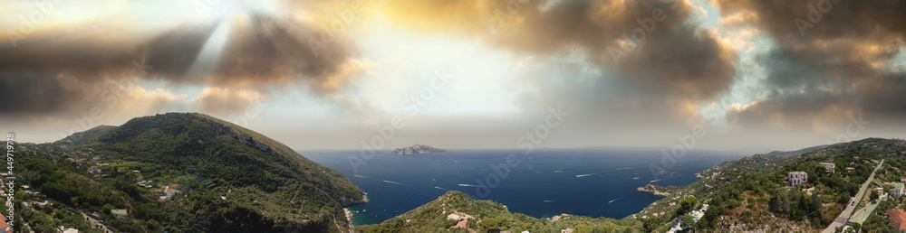 Amalfi coast near western edge at sunset, panoramic aerial view from a drone viewpoint, Italy.