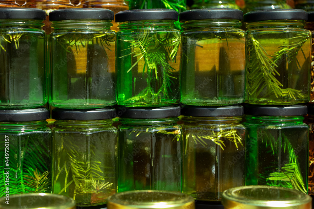 Unusual jam from young pine branches in glass jars. Useful for health, vegetarian sweet dessert Unusual jam from young pine branches in glass jars. Useful for health, vegetarian sweet dessert