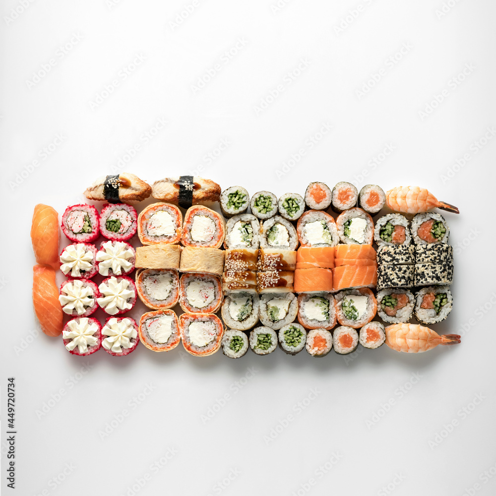 Large Sushi and Sashimi Set, Japanese rolls isolated on white background. Healthy Oriental food. Wellness concept. Flat lay. Top view. Copy space. Large Sushi and Sashimi Set, Japanese rolls isolated on white background. Healthy Oriental food. Wellness concept. Flat lay. Top view. Copy space.