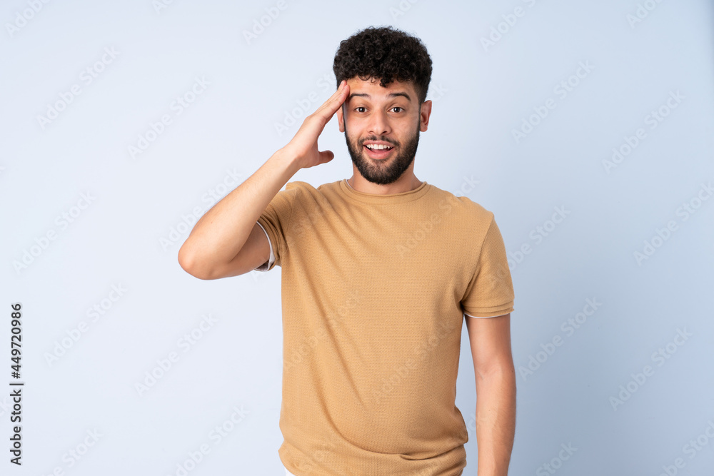 Young Moroccan man isolated on blue background has realized something and intending the solution Young Moroccan man isolated on blue background has realized something and intending the solution
