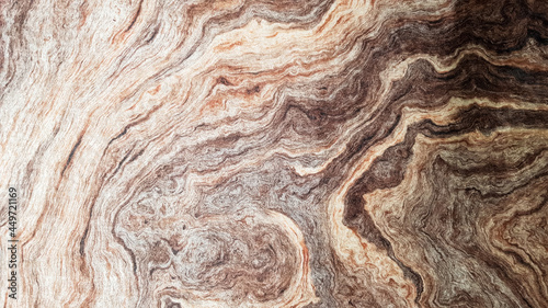 The surface of Sandstone with wavy brown veins. Sulphide agate texture. Wide image of brown natural stone texture Sphalerite. Beautiful wavy pattern of cut of Schalenblende stone close-up
