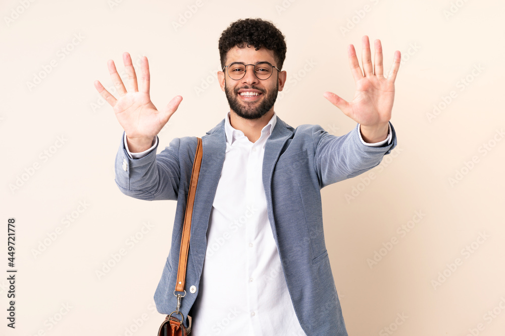 Young business Moroccan man isolated on beige background counting ten with fingers Young business Moroccan man isolated on beige background counting ten with fingers