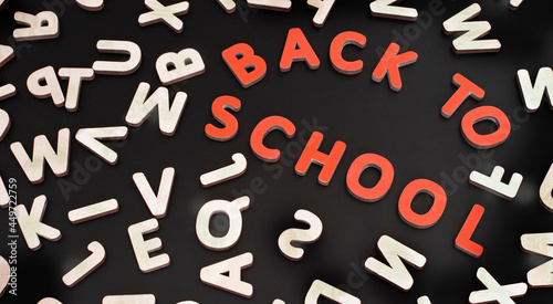 Image of letters of the english alphabet in a chaotic order on a black school board.