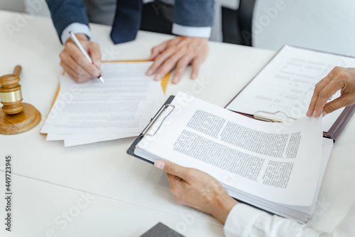 Lawyer Legal counsel presents to the client a signed contract with gavel and legal law. justice and lawyer Business partnership meeting concept.