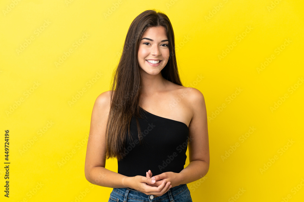 Obraz premium Young Brazilian woman isolated on yellow background laughing