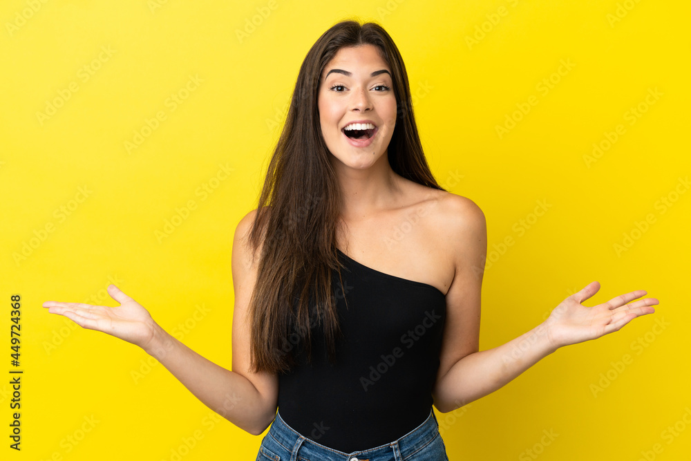 Young Brazilian woman isolated on yellow background with shocked facial expression
