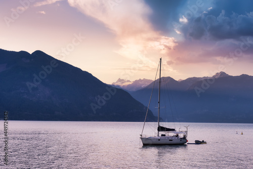Canadian Nature Mountain Landscape Background with Sailboat. Sunny Evening. Sunset Sky Art Render. View of Howe Sound, between Squamish and Vancouver, British Columbia, Canada. © edb3_16