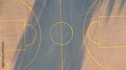 Lift off on the center of an open Basketball field, aerial view