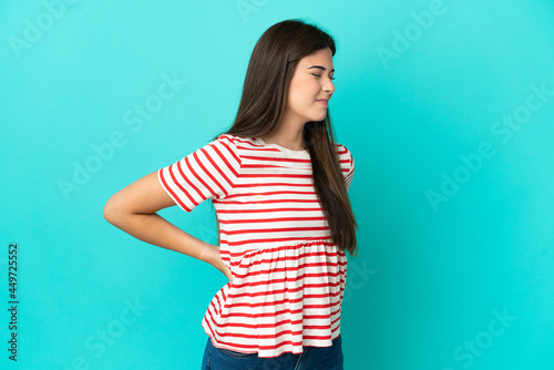 Young Brazilian woman isolated on blue background suffering from backache for having made an effort © luismolinero