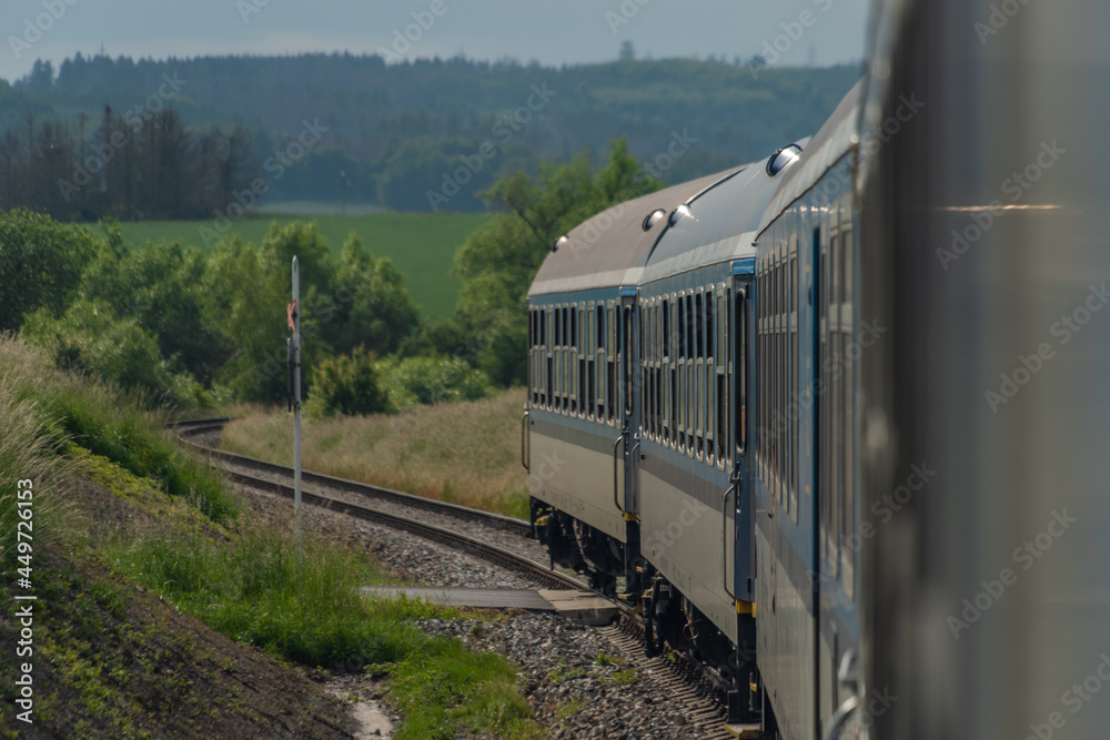 Obraz premium Electric engine and blue coach from window