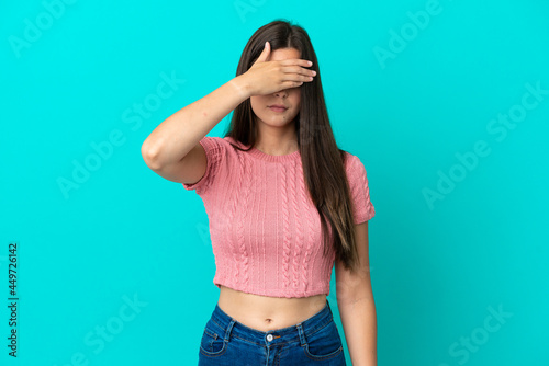 Young Brazilian woman isolated on blue background covering eyes by hands. Do not want to see something