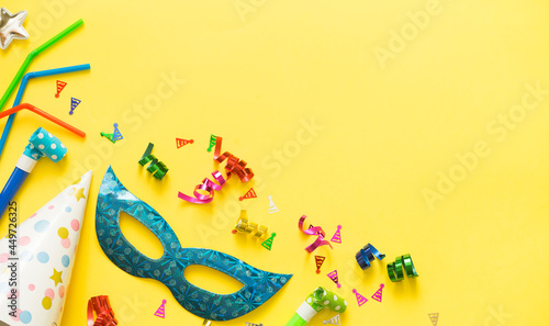 Flat lay of accessories for holiday or carnival on yellow background