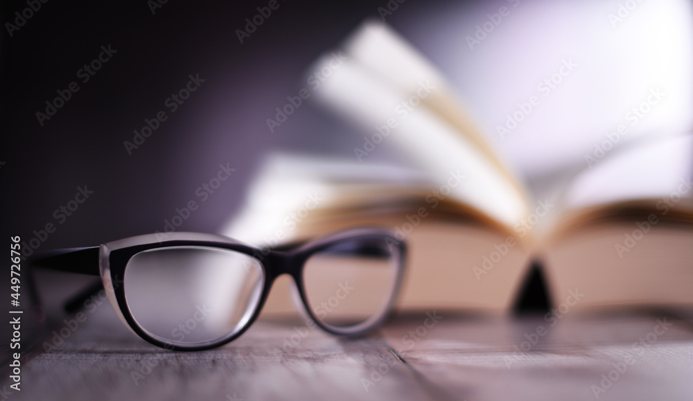 Composition with glasses and open book on the table Composition with glasses and open book on the table