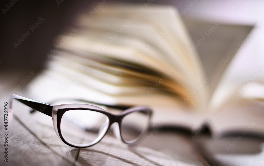 Composition with glasses and open book on the table Composition with glasses and open book on the table