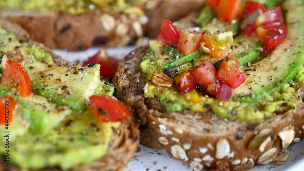 Concept of Healthy Food Avocado Toast with Tomato and Black Pepper