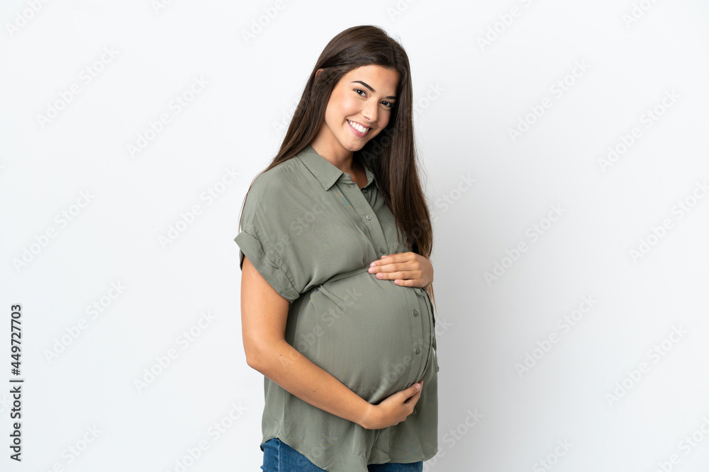 Young Brazilian woman isolated on white background pregnant and happy Young Brazilian woman isolated on white background pregnant and happy