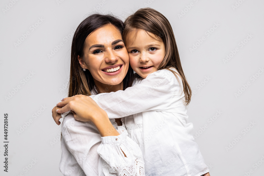 Happy young mother hugging her little daughter, smiling together, isolated on white, family concept Happy young mother hugging her little daughter, smiling together, isolated on white, family concept
