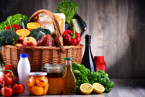 Wicker basket with assorted grocery products photo