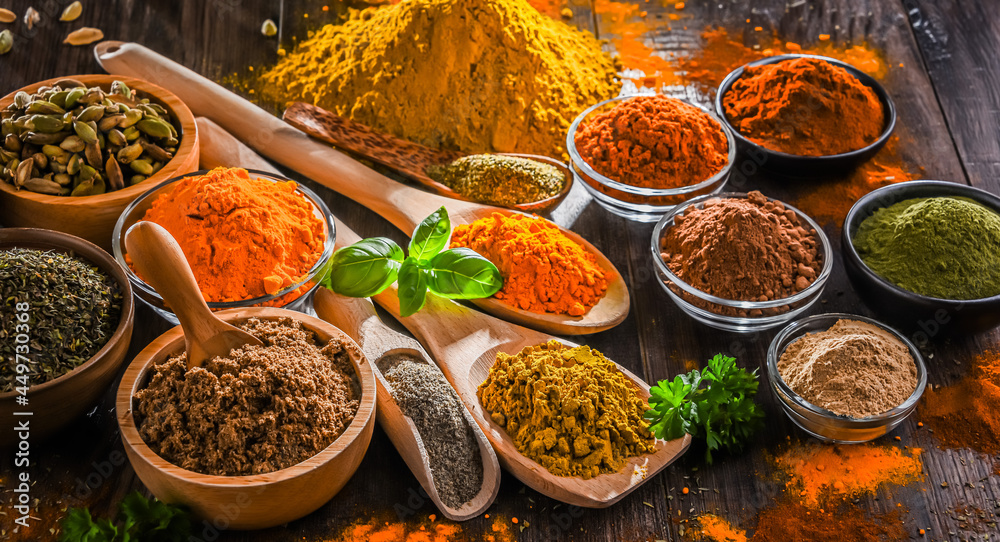 Variety of spices on wooden kitchen table. Variety of spices on wooden kitchen table.