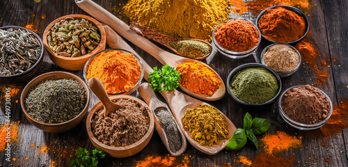 Fototapeta Naklejka Na Ścianę i Meble -  Variety of spices on wooden kitchen table.