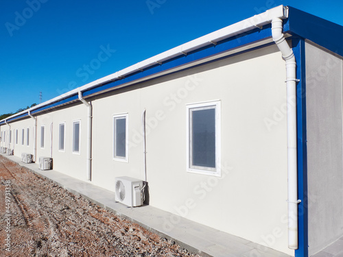 Mobile industrial building. Newly built single storey prefabricated industrial building. Prefabricated office container building at construction site