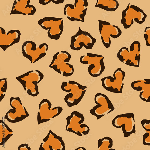 Leopard heart seamless pattern. Vector animal print. Black and orange spots on beige background. Jaguar, leopard, cheetah, panther fur. Leopard skin imitation can be painted on clothes or fabric.