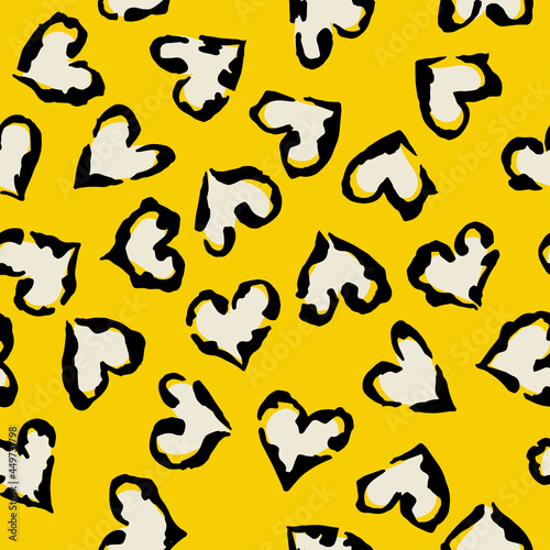Leopard heart seamless pattern. Vector animal print. Black and white spots on yellow background. Jaguar, leopard, cheetah, panther fur. Leopard skin imitation can be painted on clothes or fabric.