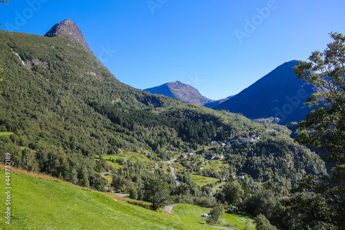 Beautiful views from Fosserasa hiking trail of mountains, Villages and valley landscape close to Geiranger fjord, Norway. Summers day with clear blue sky over the scenery. photo
