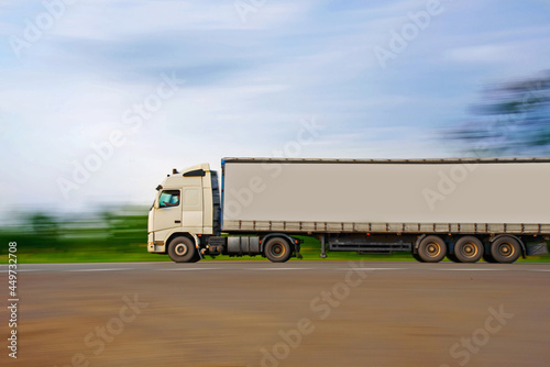 Trailer on the road in motion. Delivery of goods by road.