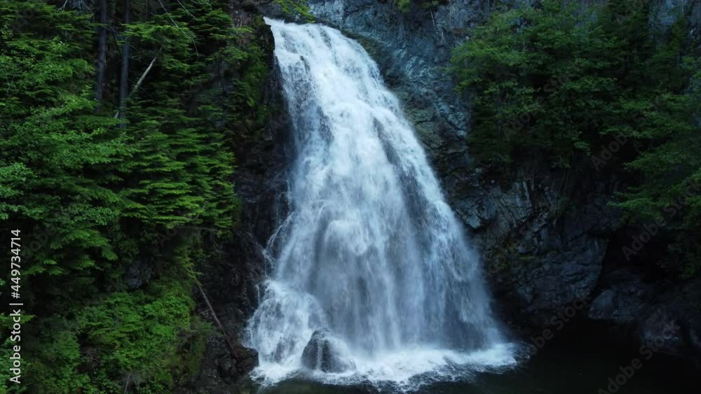 Water flowing over the edge of a waterfall in a forest Water flowing over the edge of a waterfall in a forest