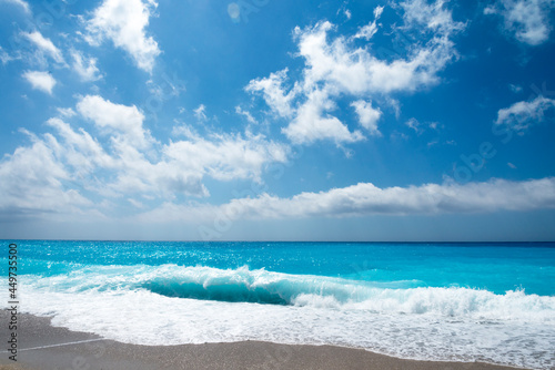 Tropical sand beach and blue sky, hot summer day, waves on the beach
