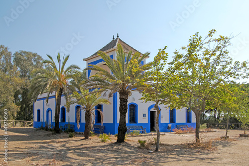 Old house of the guardian in white and blue of the recreational area of ​​the beach of Casita Azul in Isla Cristina, Huelva, Andalusia, Spain photo