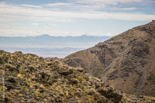 Beautiful Summer scenery: yellow and brown mountains under the blue cloudy sky. Central Asian mountain background. 