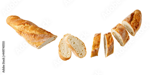 Cutting fresh baked loaf wheat baguette bread flying isolated on white photo