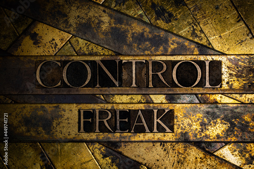 Control Freak text on vintage textured copper and gold background photo