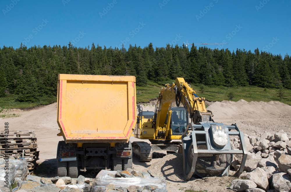 Crawler Excavators wtih Sifting and grinding bucket for the separation and truck in quarry Crawler Excavators wtih Sifting and grinding bucket for the separation and truck in quarry