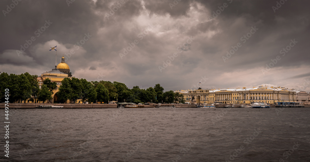 View from the Neva River on the Admiralty building and St. Isaac's Cathedral and the Constitutional Court of the Russian Federation against a stormy sky
